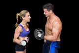 Crossfit couple posing with dumbbells