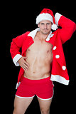 Muscular man posing in sexy santa outfit
