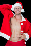 Smiling muscular man posing in sexy santa outfit