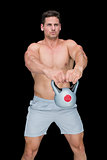 Focused bodybuilder swinging up kettlebell