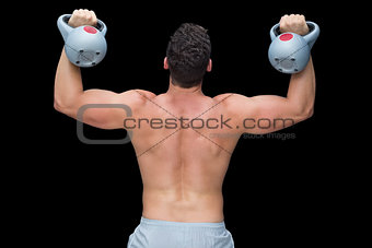 Strong bodybuilder lifting up kettlebells