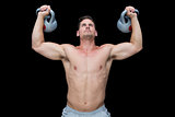 Strong bodybuilder lifting up kettlebells