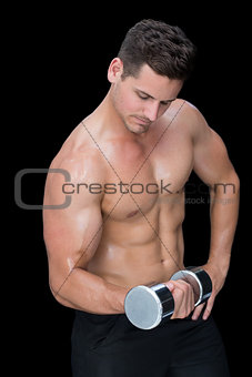 Focused crossfitter lifting up heavy dumbbell