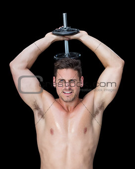 Strong crossfitter lifting up heavy black dumbbell behind head