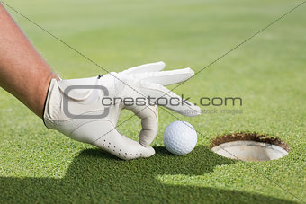 Golfer trying to flick ball into hole