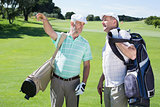 Golfer friends chatting and holding their golf bags