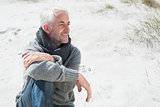 Attractive man smiling on the beach in scarf
