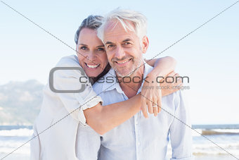 Attractive married couple posing at the beach