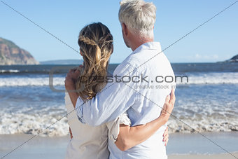 Couple on the beach looking out to sea