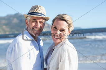 Happy couple standing on the beach together