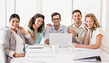 Casual business team smiling at camera during meeting