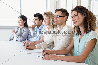 Casual business team listening during meeting