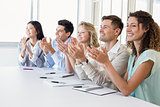 Casual business team clapping at presentation