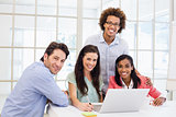 Casual business team smiling at camera during meeting