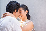 Asian couple embracing and smiling