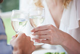 Young couple toasting with white wine