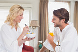 Couple having breakfast in their bathrobes