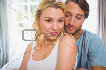 Happy couple relaxing on bed