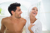 Attractive couple laughing in towels