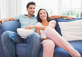 Attractive couple watching tv on the couch