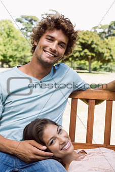 Cute couple relaxing on park bench