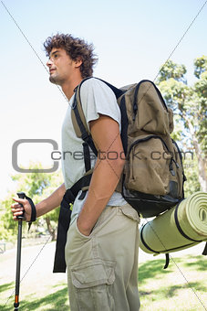 Handsome hiker holding walking pole