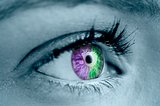 Purple and green eye on grey face