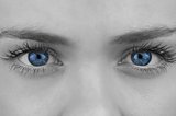Blue eyes of pretty female face