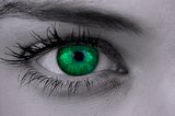 Bright green eye on female face
