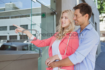 Stylish young couple window shopping
