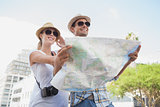 Young tourist couple using the map