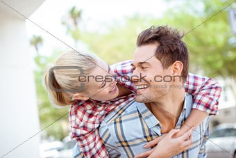 Man giving his pretty blonde girlfriend a piggy back