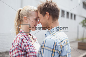 Hip young couple hugging and facing each other