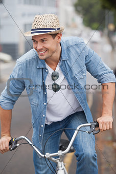 Hip young man in denim on his bike