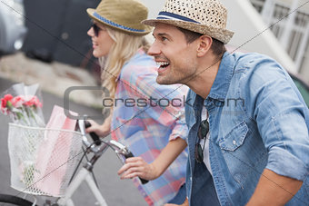 Hip young couple on their bikes