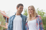 Hip young couple smiling and standing