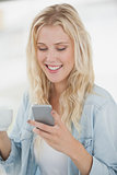 Cute blonde texting on phone