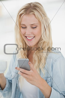 Cute blonde texting on phone