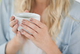 Cute blonde holding white mug