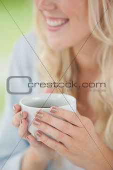 Cute blonde holding white mug