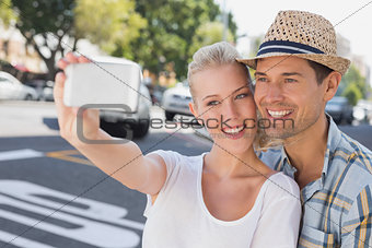 Young hip couple taking a selfie