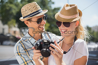 Hip young couple looking at their camera