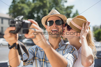Hip young couple taking a selfie with camera