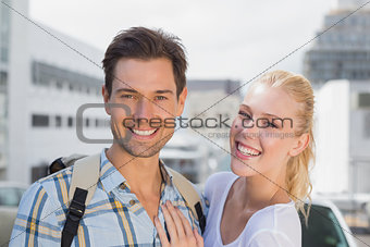 Hip young couple smiling at camera