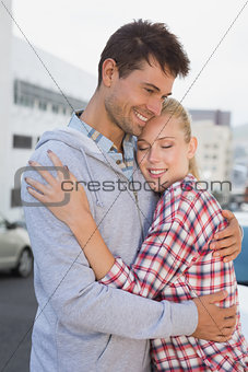 Hip young couple hugging in the road