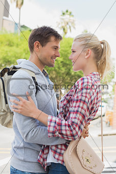 Young tourist couple hugging each other