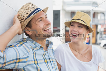Young hip couple sitting on bench