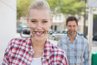 Young hip couple smiling at camera