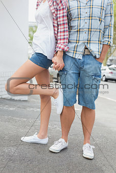 Couple in check shirts and denim holding hands