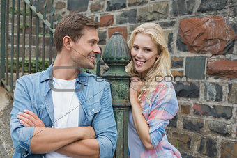 Hip young couple standing by steps